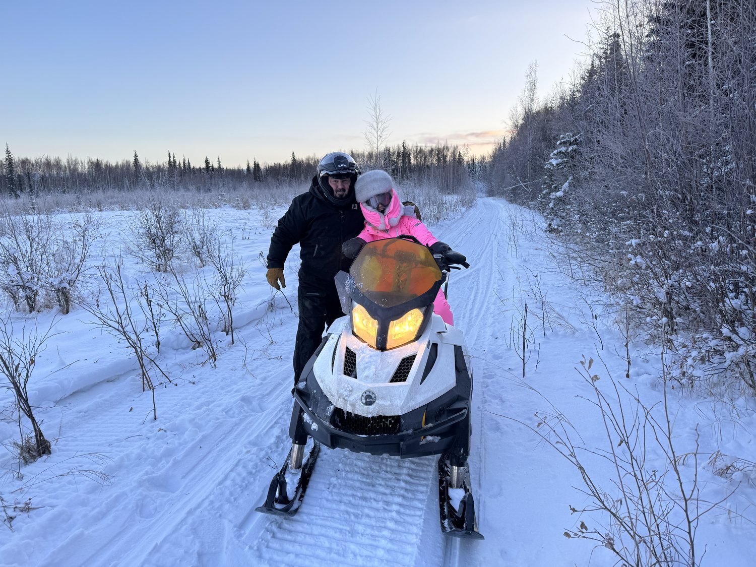 Seth and Maiia Church on a snowmachine